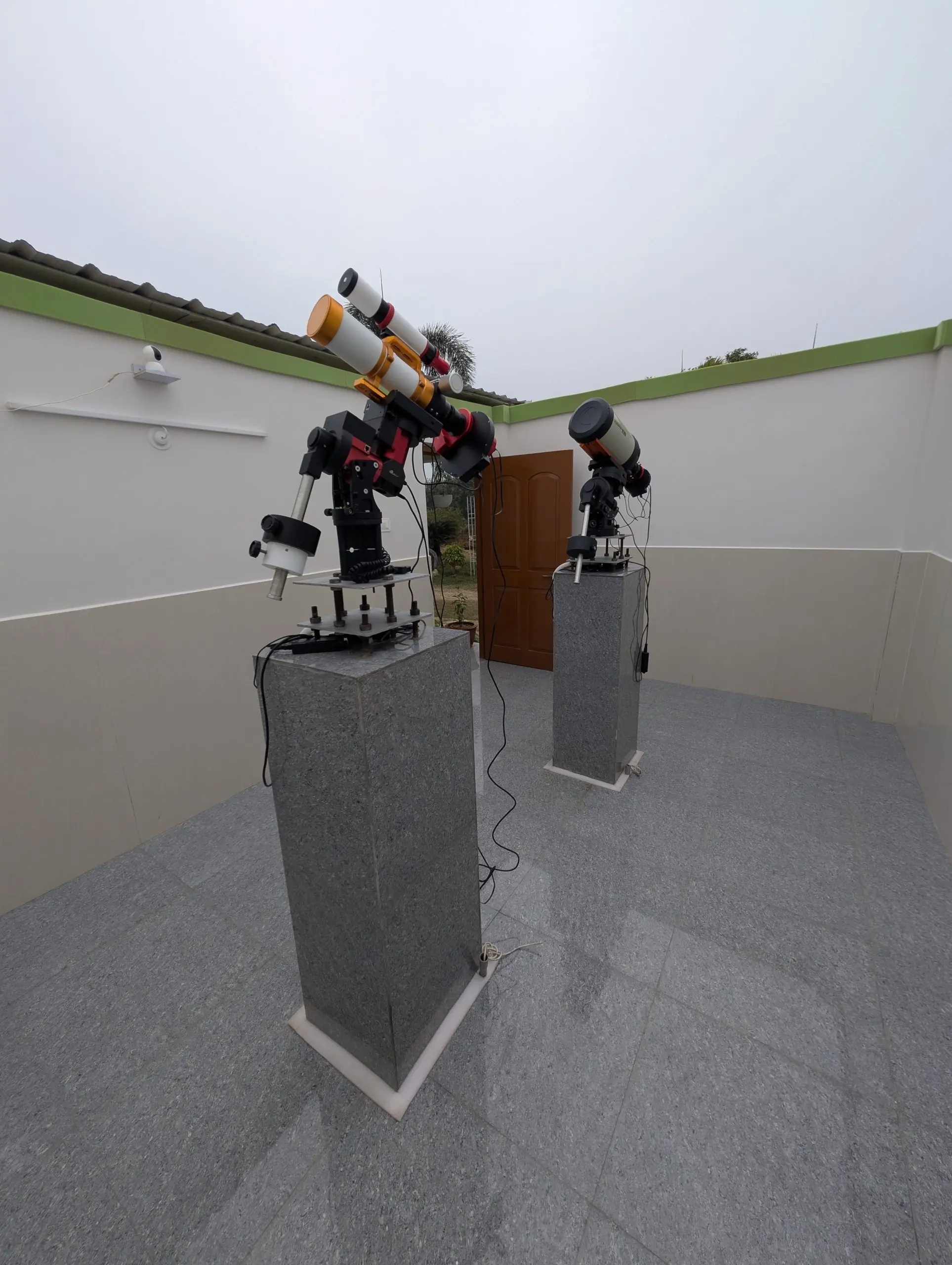 North view of the dual pier astrophotography setup showing spatial clearance inside the roll-off roof observatory