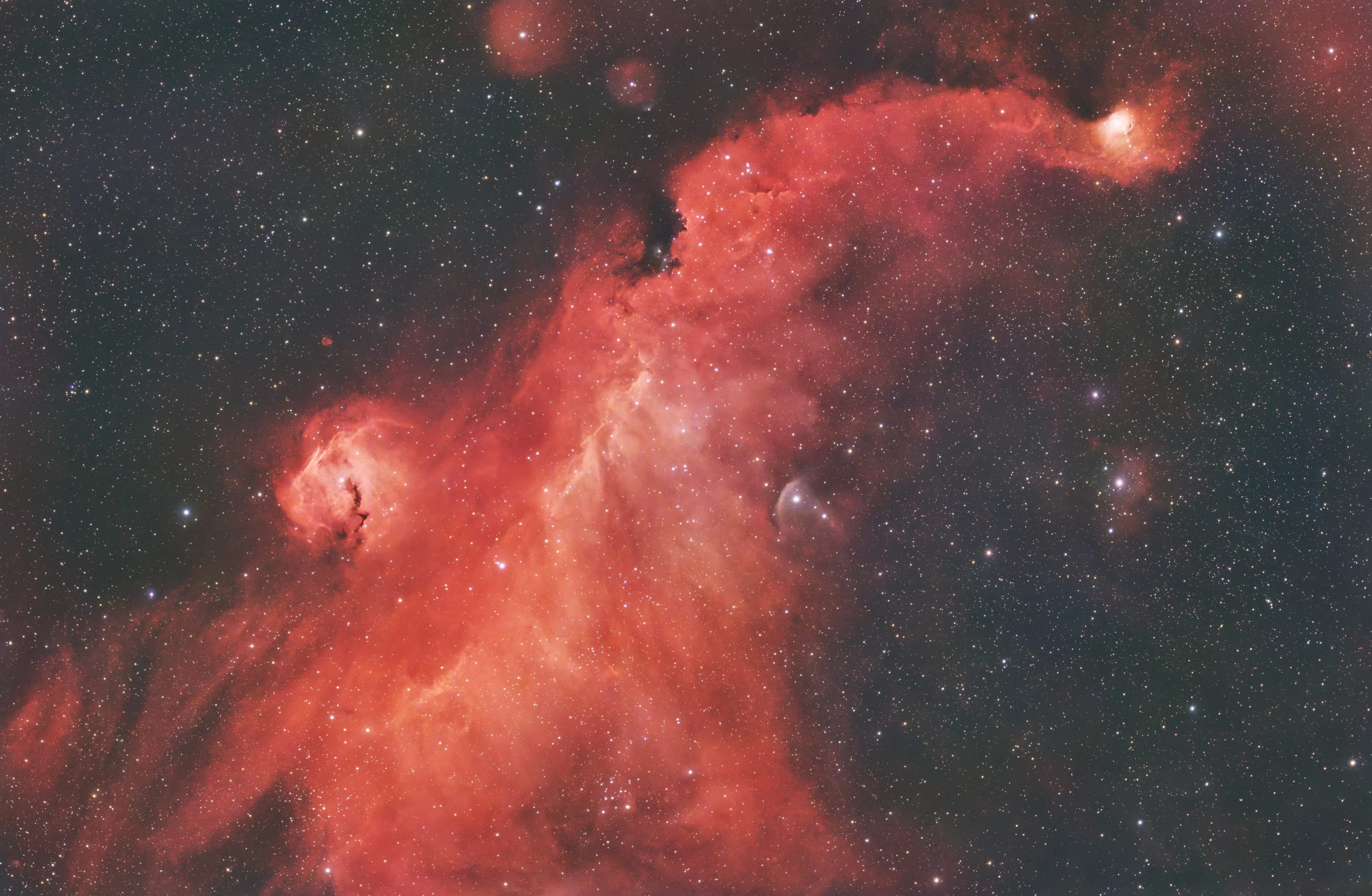 A linked stretch of the Seagull Nebula demonstrating how the dominant Hydrogen-Alpha signal obscures faint Oxygen-III details, rendering the structure entirely red.