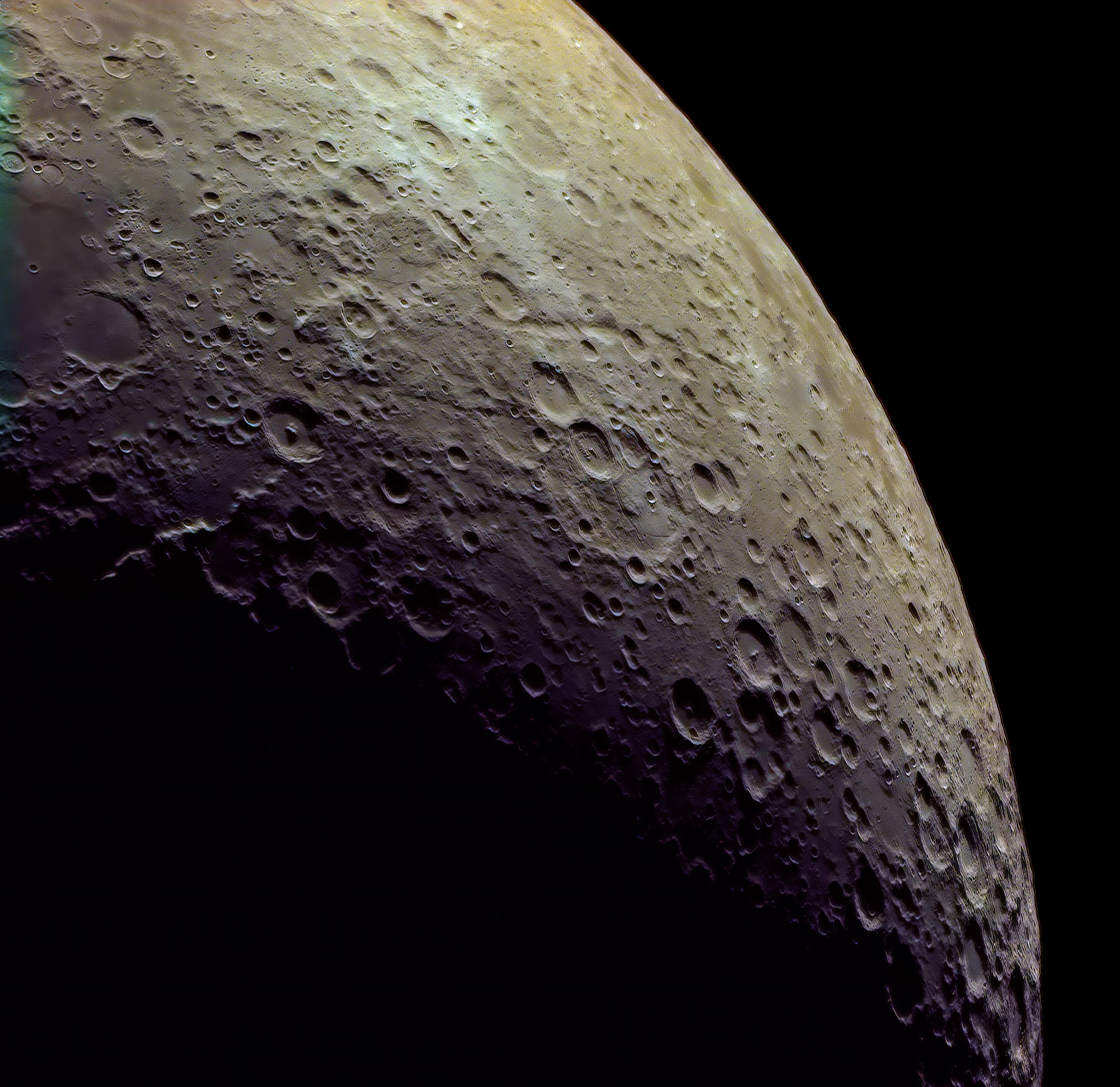Extreme close-up of the lunar terminator showing long shadows cast by deep craters along the limb.