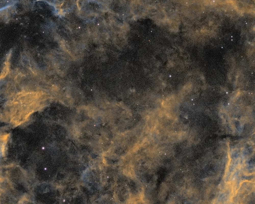1:1 crop of the dark dust lanes inside the IC 443 shell, before and after targeted colour-noise reduction and darkening - Before