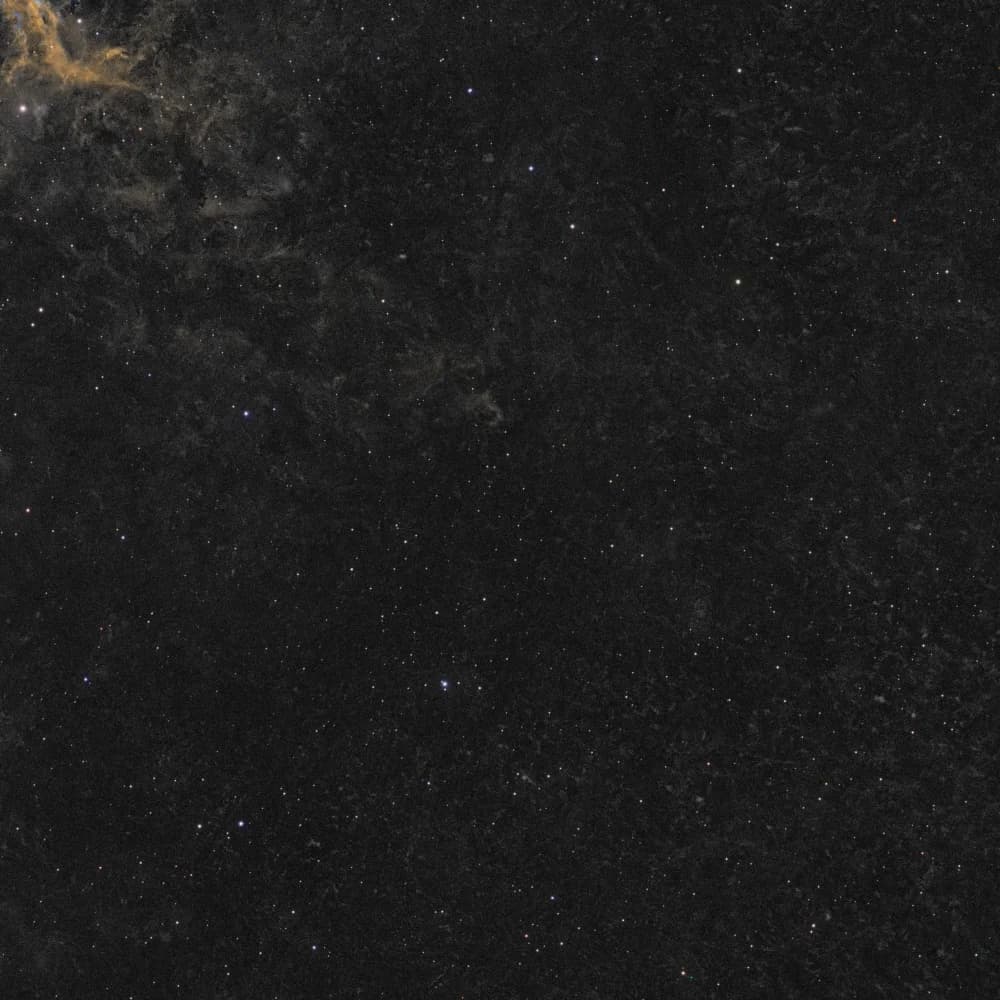 Right-hand sky of the IC 443 frame, before and after removing worm-like streaks left by backfocus comet stars - Before